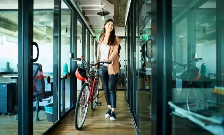 businesswoman arriving to work on bike