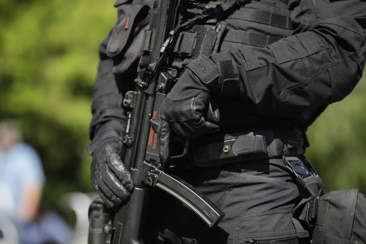 Bucharest, Romania - July 29, 2020: Details with an officer from the Special Actions and Intervention Service (SIAS), from the Romanian Police, holding a Heckler & Koch MP5