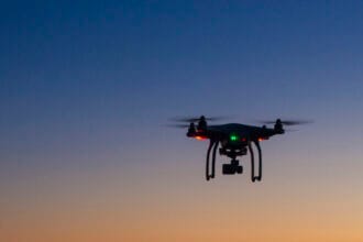 drone flying over ocean at dawn