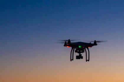drone flying over ocean at dawn