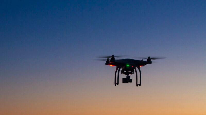 drone flying over ocean at dawn
