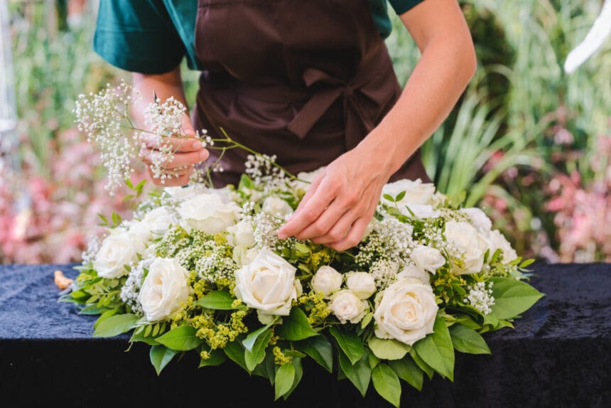 gardener woman creating grave decoration